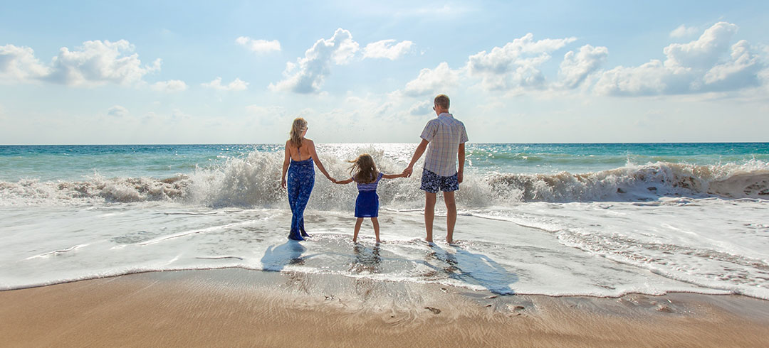 Family at the beach benefiting from health insurance