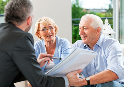 Elderly couple talking to insurance agent