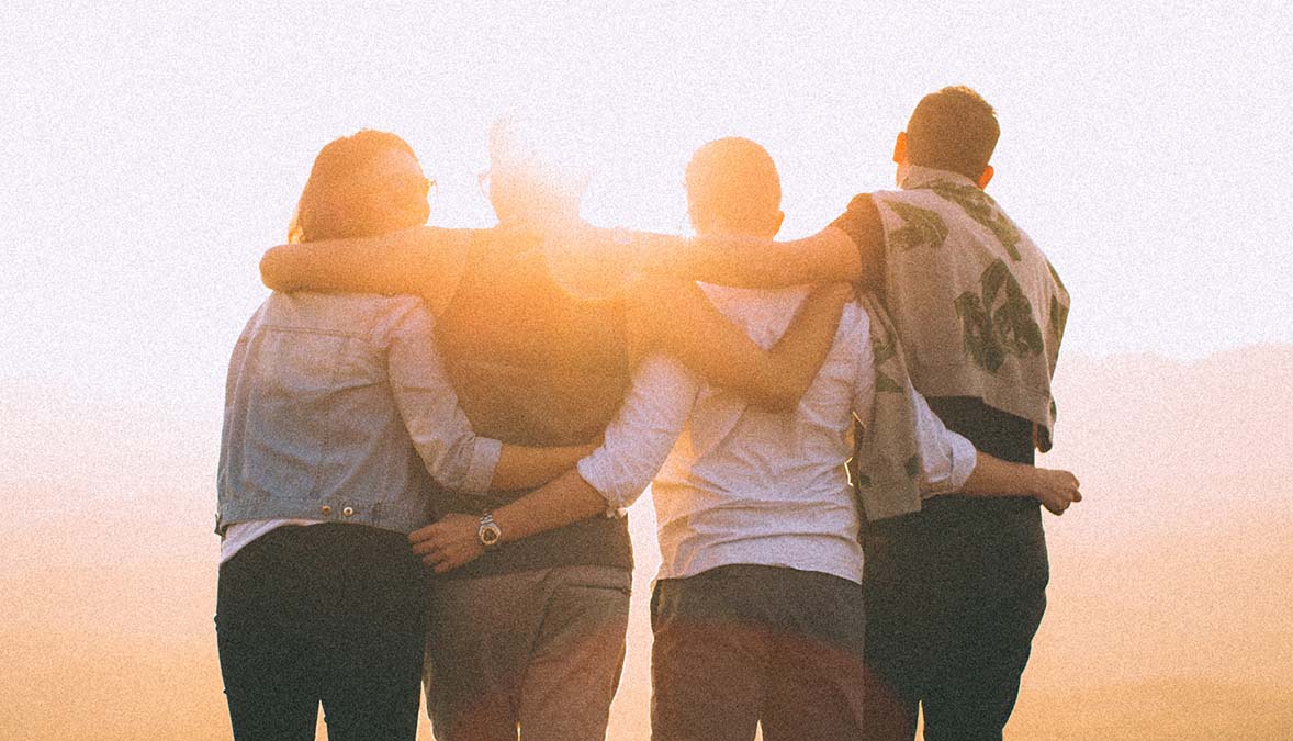 4 people arm and arm