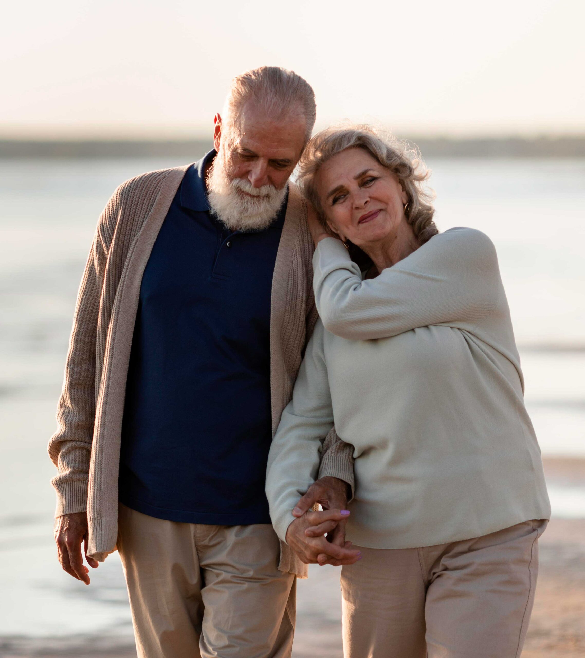 senior couple walking on beach